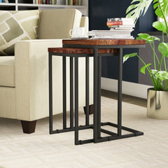 nesting tables set with wood tops and metal frames, next to a sofa