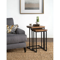 nesting tables set with wood tops and metal frames, next to a sofa