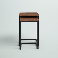 Nesting tables set with wood tops and metal frames, next to a sofa