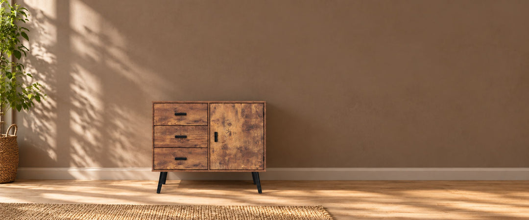 Rustic brown three-drawer storage cabinet with one door and black legs in a naturally lit home entryway