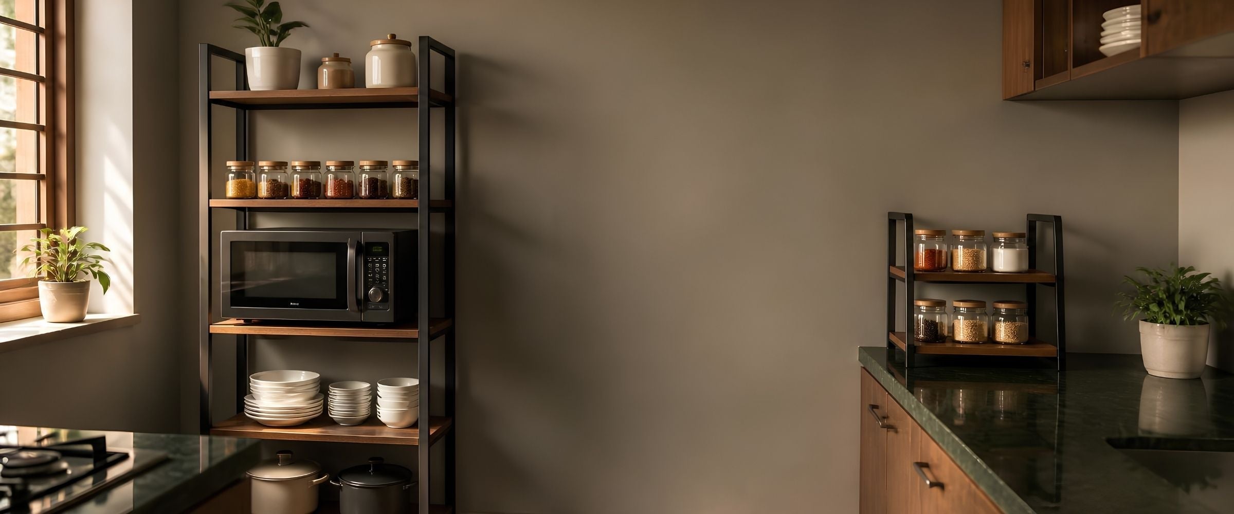 Freestanding black metal and wood kitchen organizer rack holding a microwave, spice jars and stacked plates in a modern kitchen
