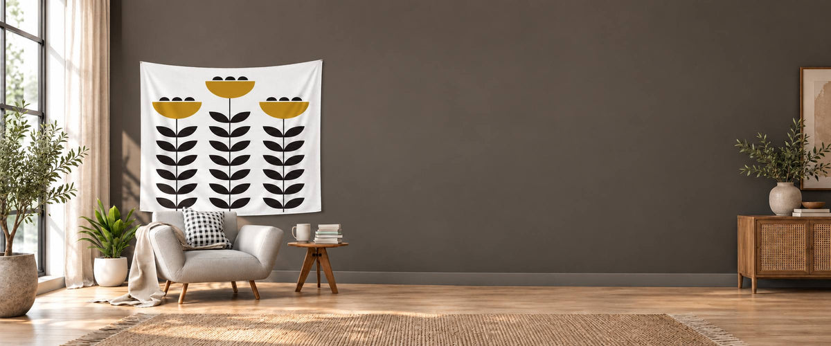 White Meralune tapestry with mustard flowers and charcoal leaves above an armchair in a naturally daylit lounge
