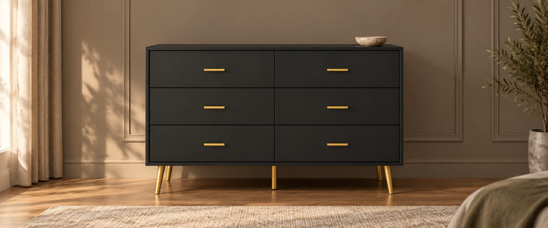 Black six-drawer Kamily dresser with gold handles and legs in a daylit bedroom