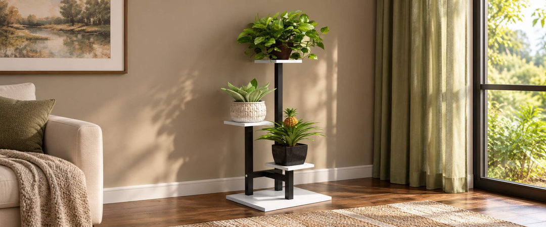 Three-tier black and white plant stand with potted greenery in a sunlit neutral living room