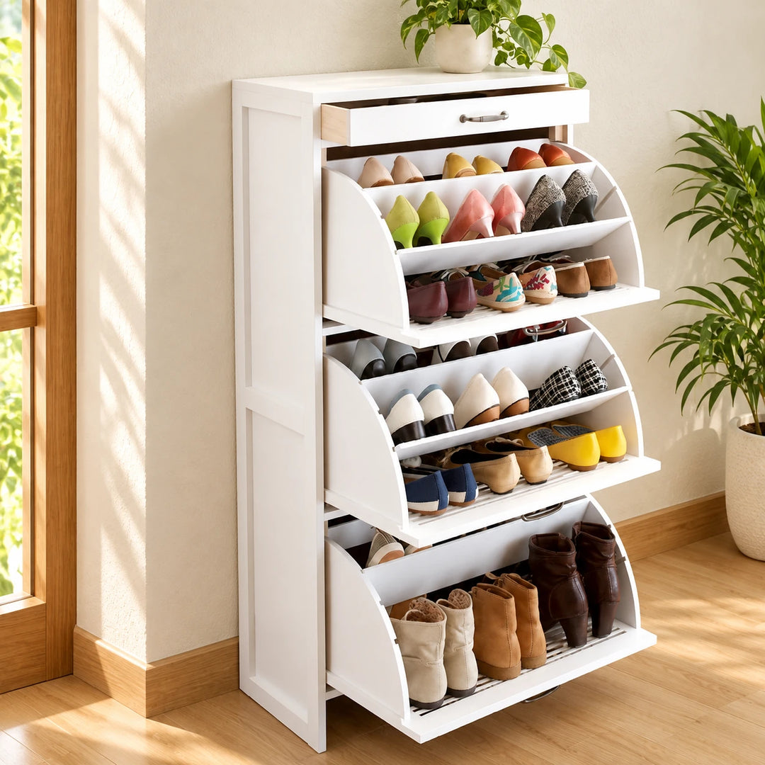 White three-tier shoe cabinet with open compartments and top drawer in a sunlit entryway