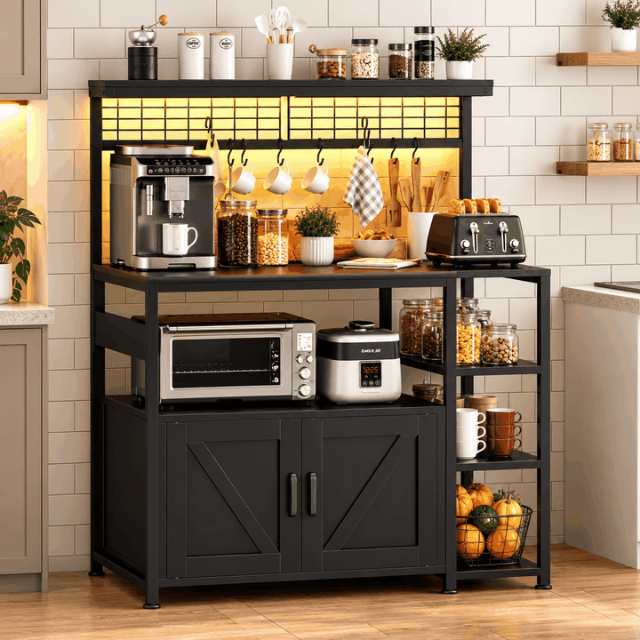 Black bakers rack with barn door cabinet, microwave and coffee machine in bright kitchen