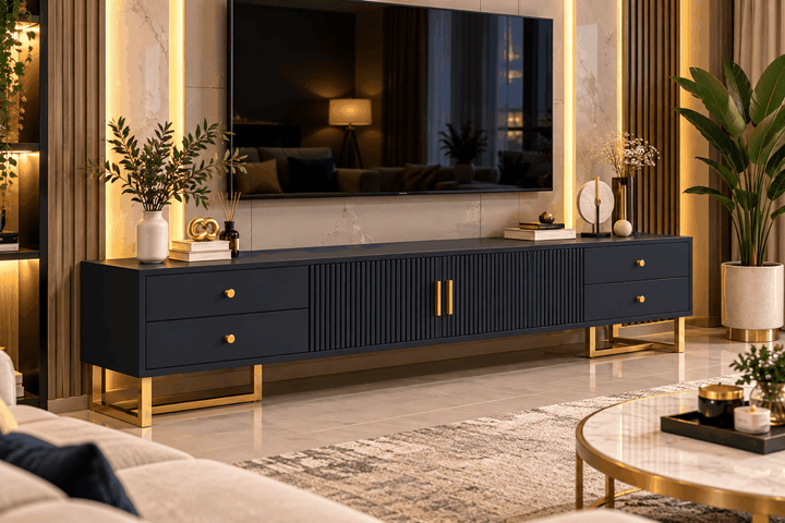Dark fluted TV console with gold handles and legs beneath a wall-mounted television