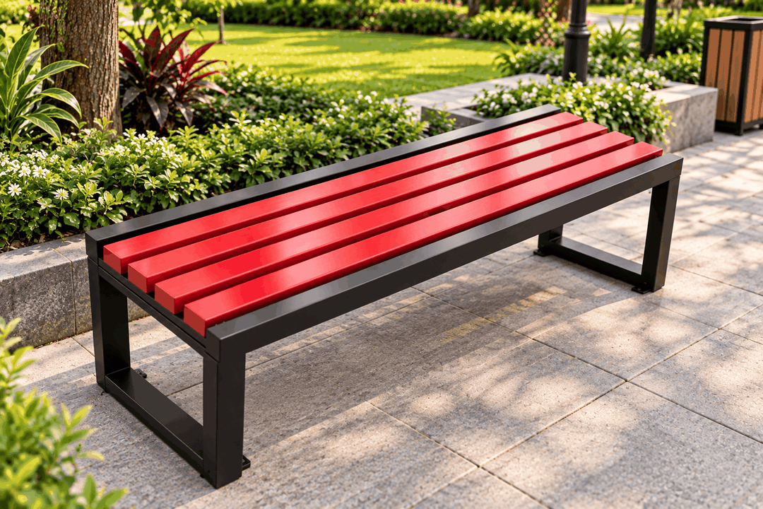 Red slatted outdoor bench with a black frame beside a garden path