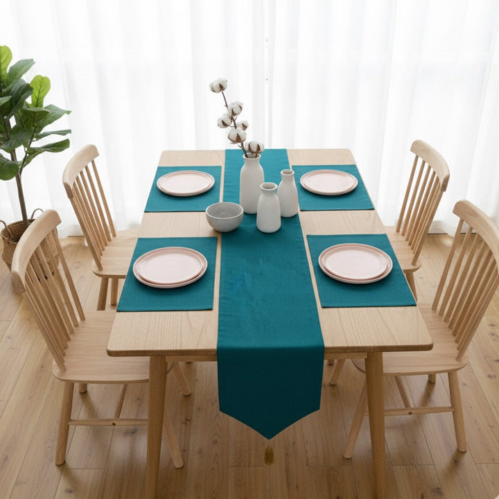 Teal table runner with matching placemats on six-seat dining table
