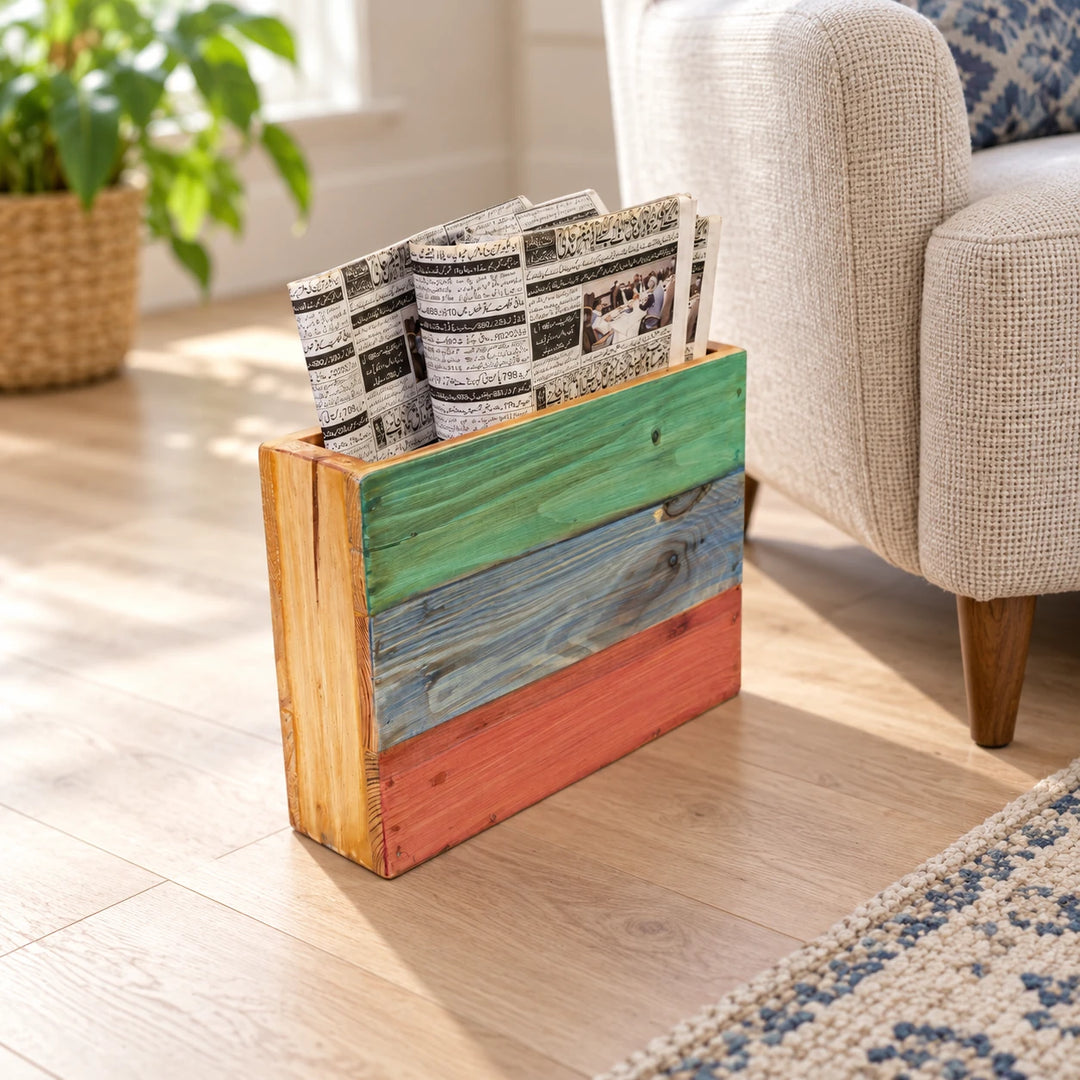 Multicoloured wooden magazine holder beside a sofa