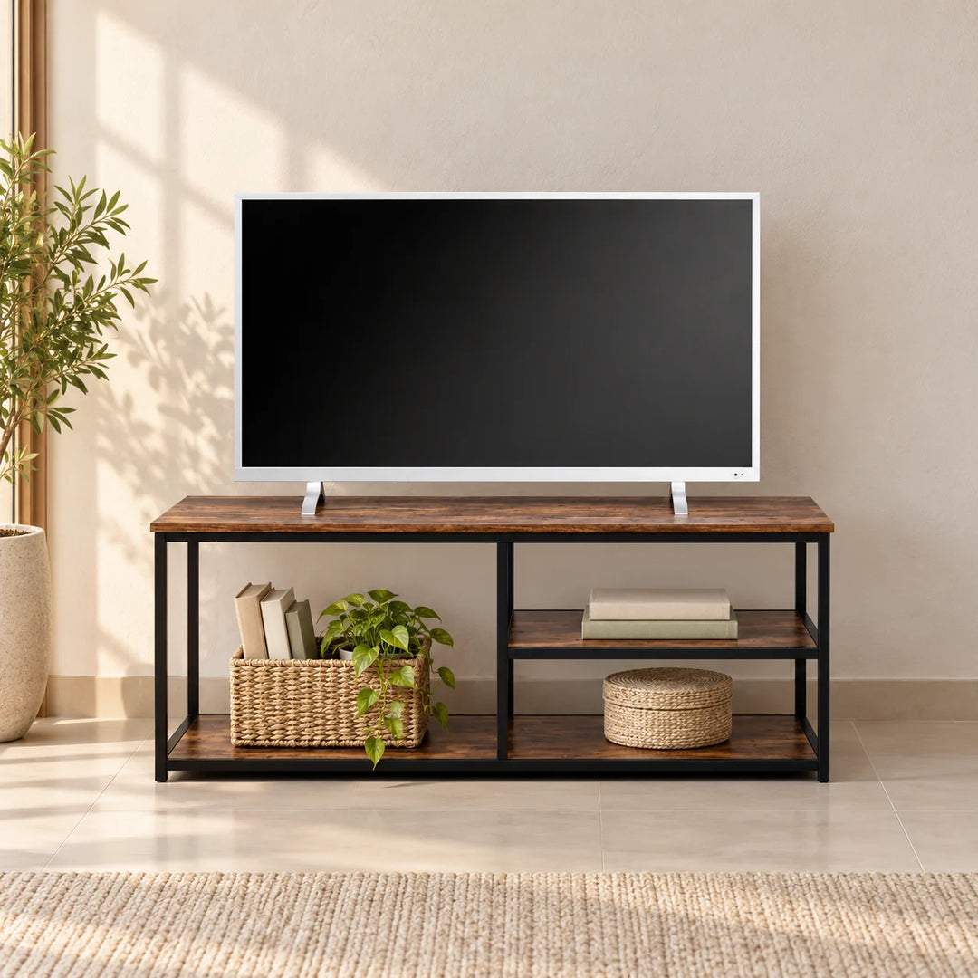 Armadio brown wood-effect media console with black metal frame and open shelves, styled against a living-room wall with a television and baskets.