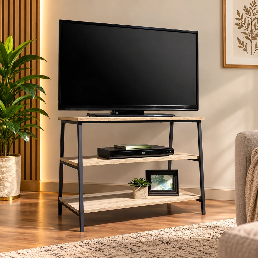 Three-tier TV console with light wood shelves and black frame in a sunlit living room