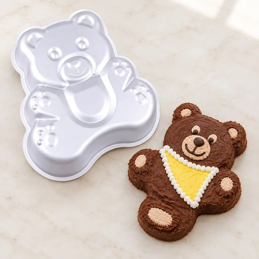 Bear-shaped baking mould beside a decorated bear cake