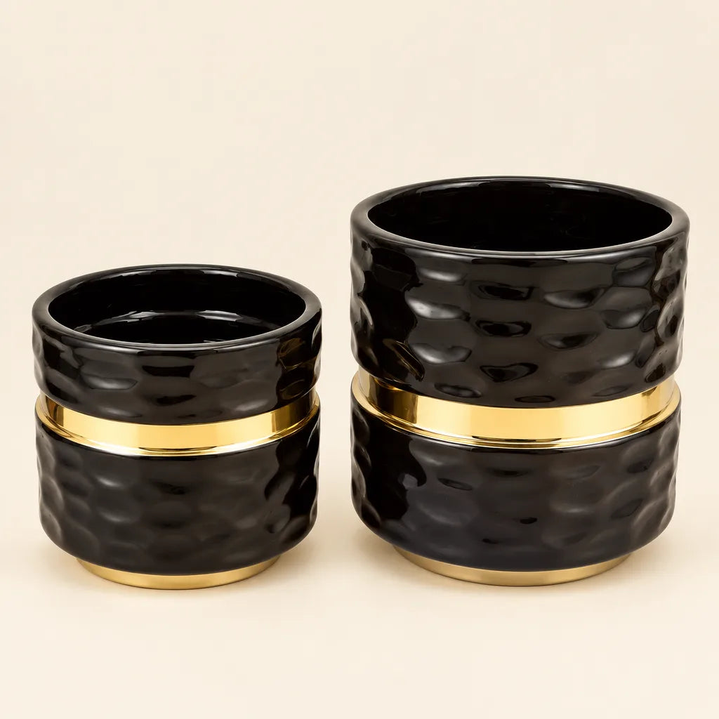 Pair of black textured ceramic vases with gold band, small and large