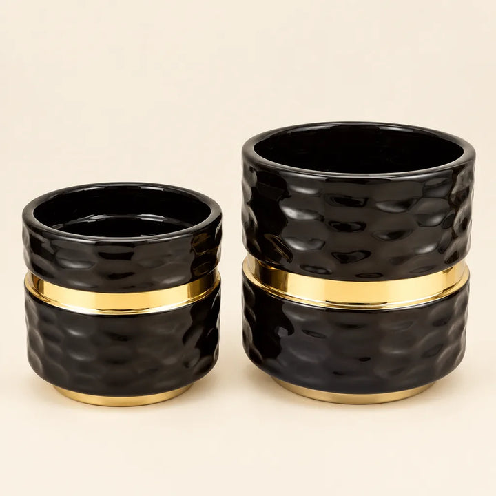Pair of black textured ceramic vases with gold band, small and large