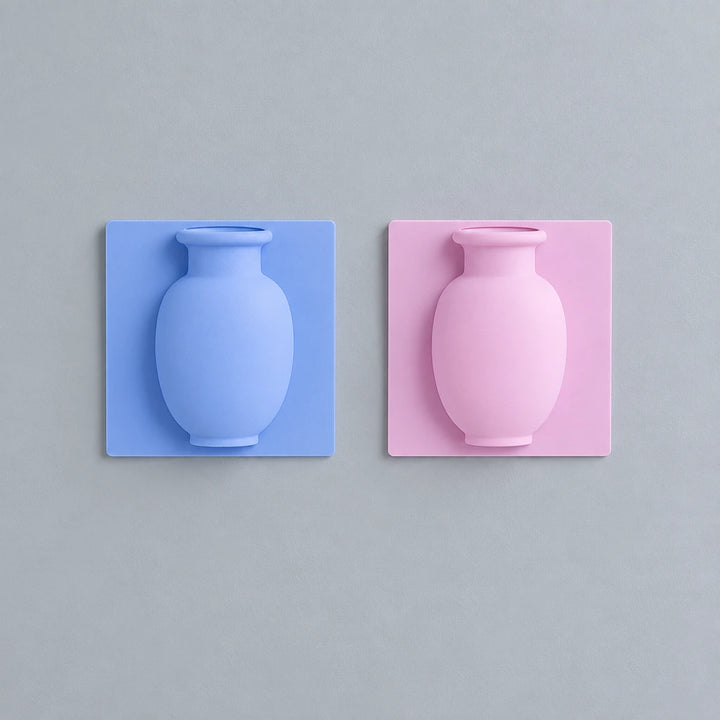 Blue and pink vase wall stickers mounted side by side on grey wall above wooden table