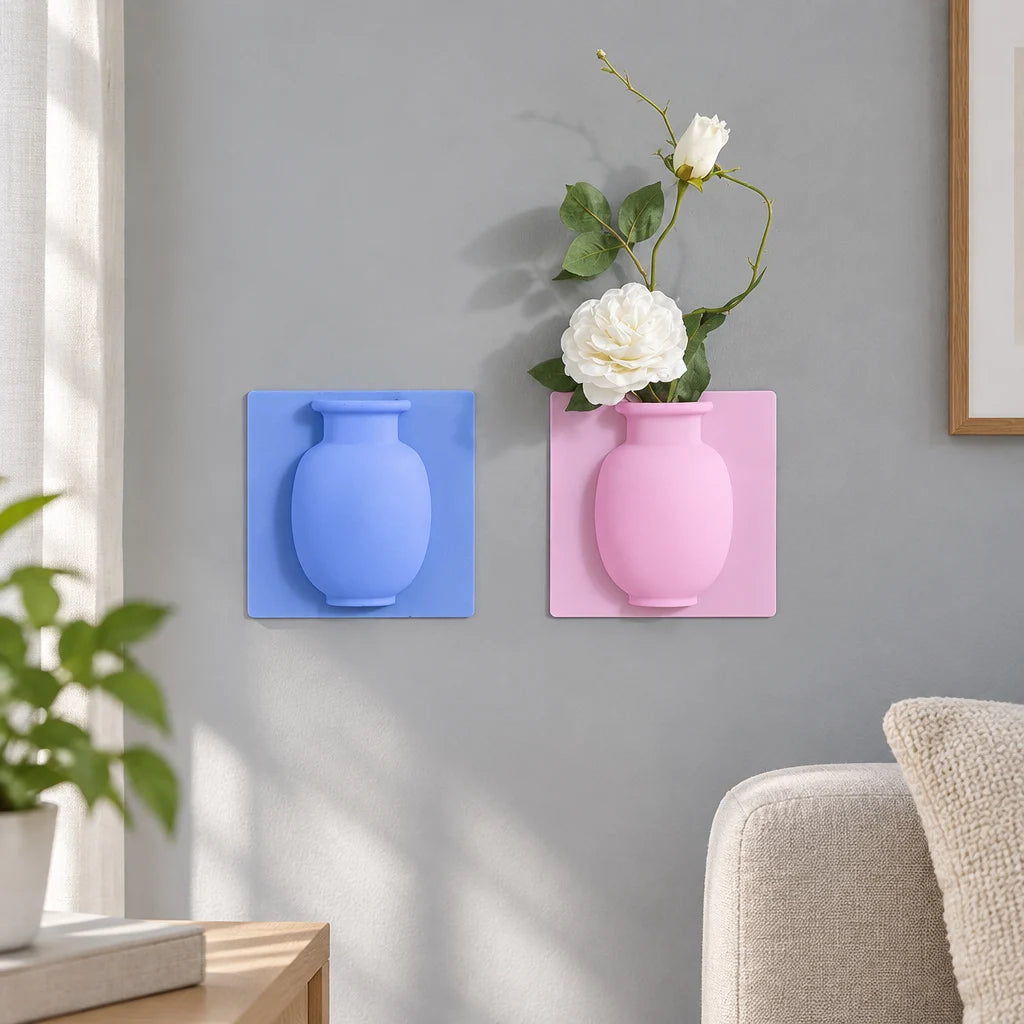 Blue and pink silicone vase wall stickers on grey wall, pink one holding white flowers