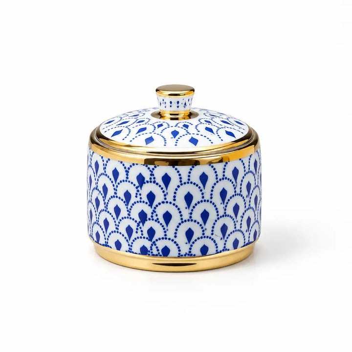 Classical ceramic jar with blue fan pattern and gold rim on white background