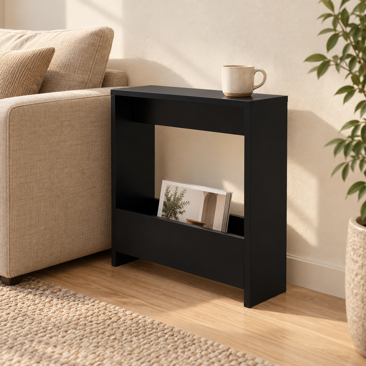 Black narrow side table with magazine pocket beside a beige sofa in natural daylight