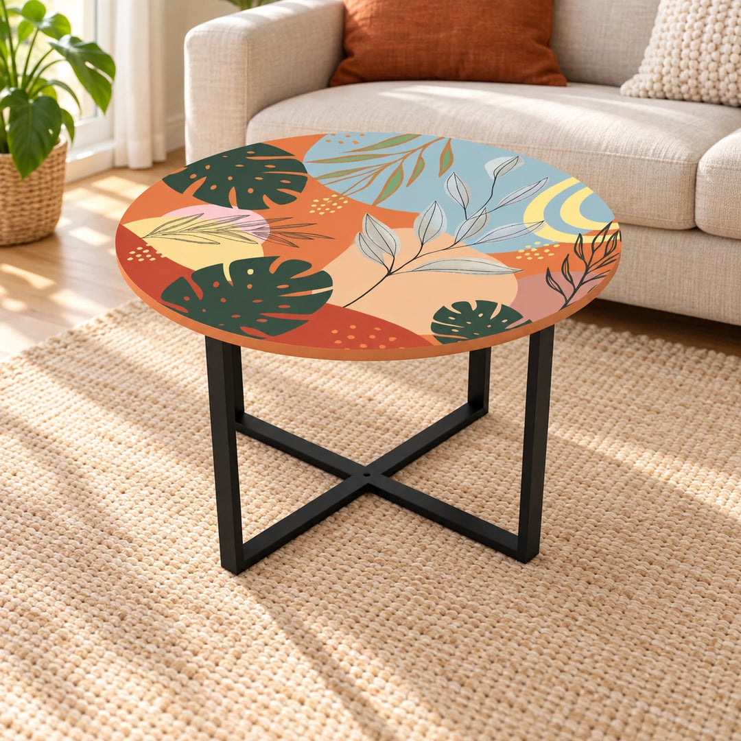 Buggard round botanical printed coffee table with black crossed base in a sunlit living room