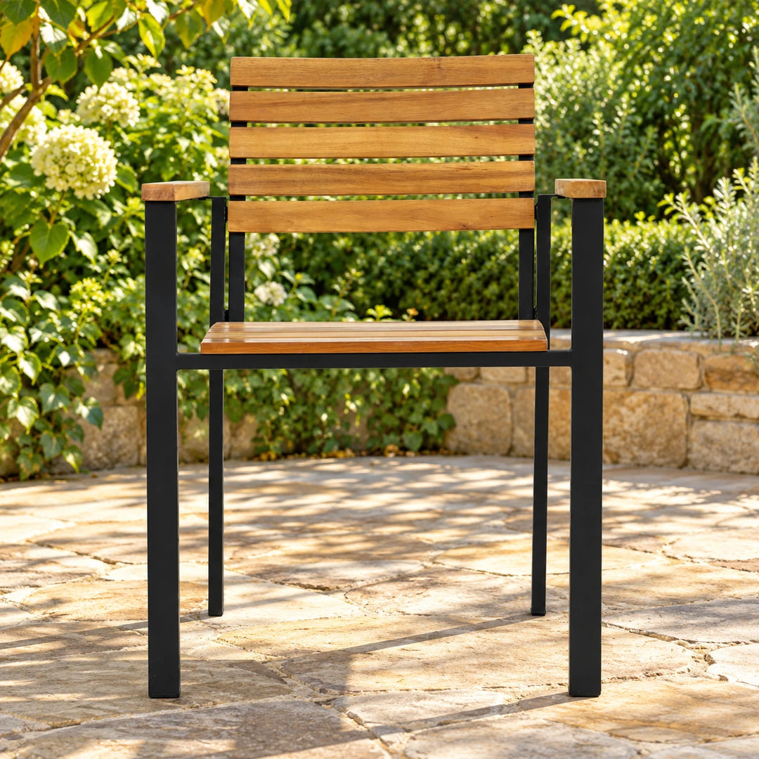 Single Burl outdoor armchair with five wood backrest slats and black frame on a garden patio