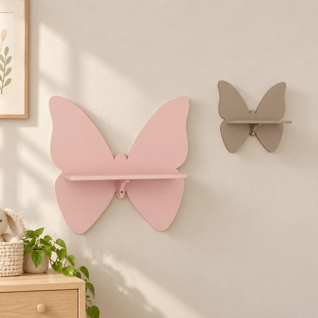 Pink and taupe butterfly-shaped wall shelves in a naturally lit nursery setting