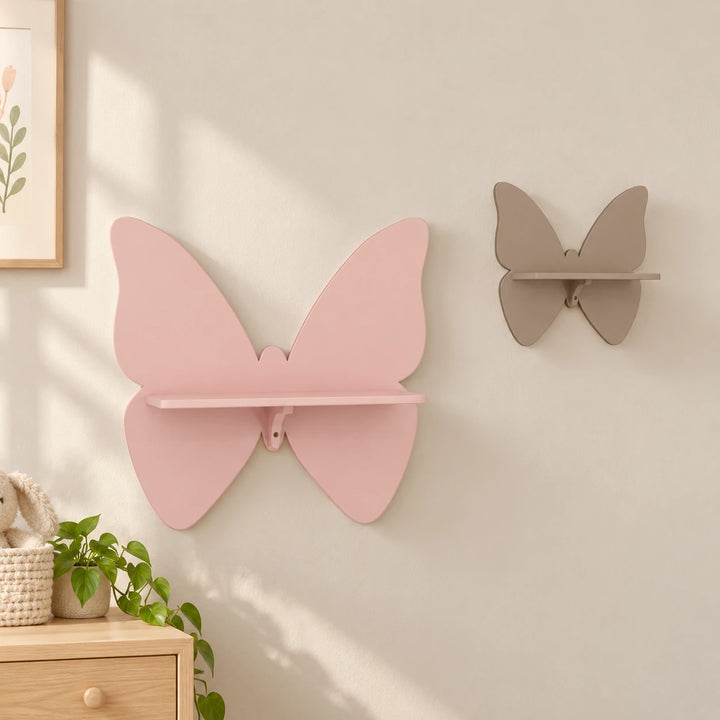 Pink and taupe butterfly-shaped wall shelves in a naturally lit nursery setting