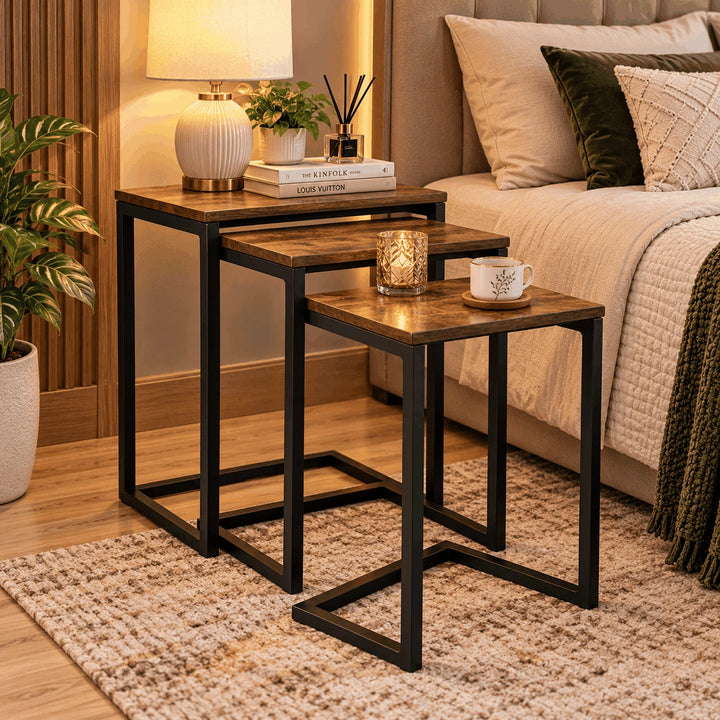 Three C-type nesting tables arranged in a bedroom setting
