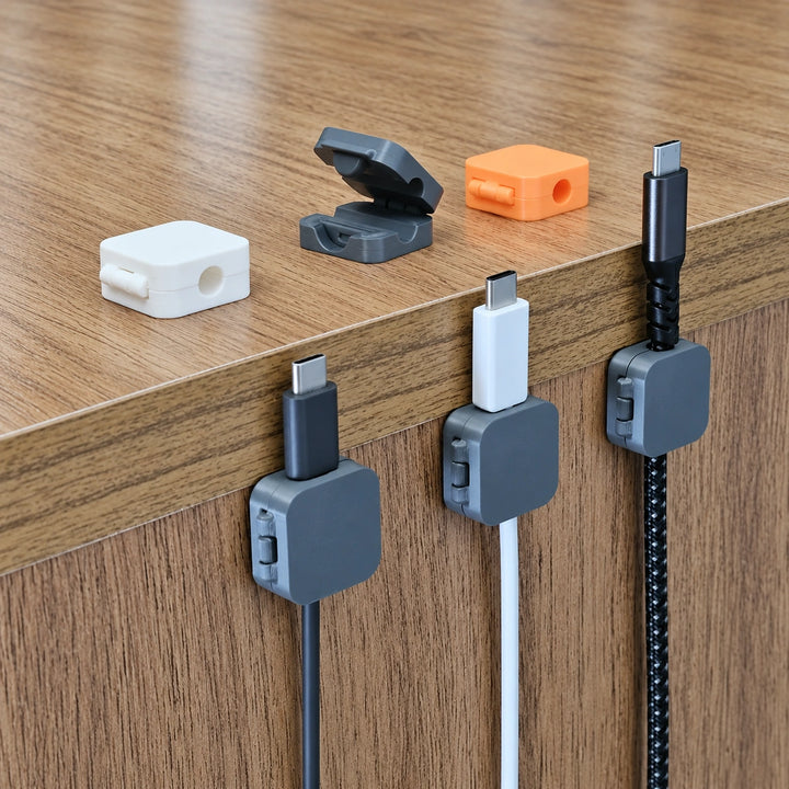 3D printed cable organizer clips showing hinged lids and desk mounting