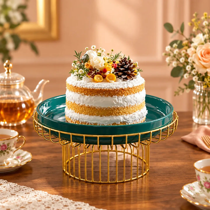 Teal cake serving tray on a gold cage-style stand, topped with a decorated cake