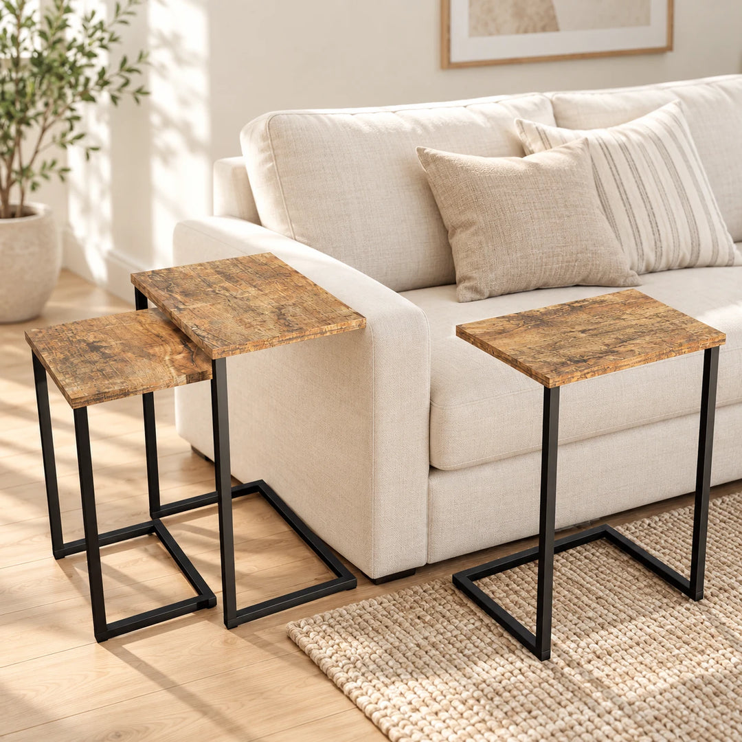 Centra set of three 4004 nesting side tables with black C-shaped frames beside a sunlit sofa