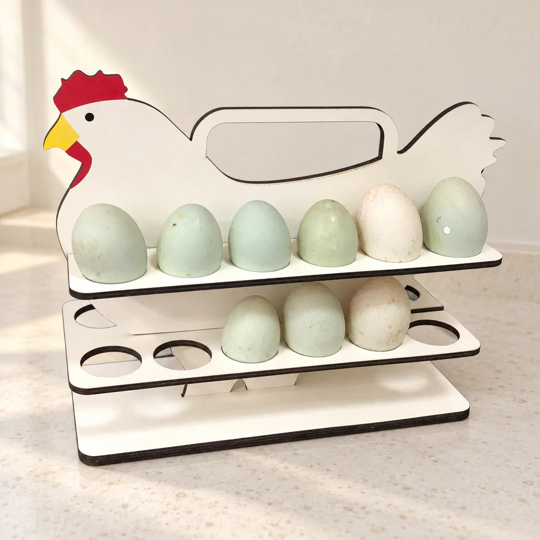 Cream chicken-shaped two-tier egg holder with red comb and yellow beak, styled with eggs on a light kitchen countertop