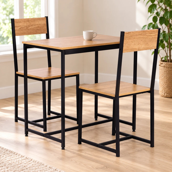 Light wood dining table and two matching black-frame chairs in a sunlit dining nook