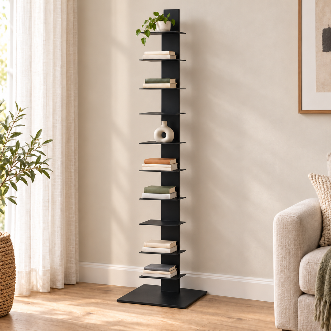 Black metal ten-tier vertical bookcase with books and a small plant against a living room wall