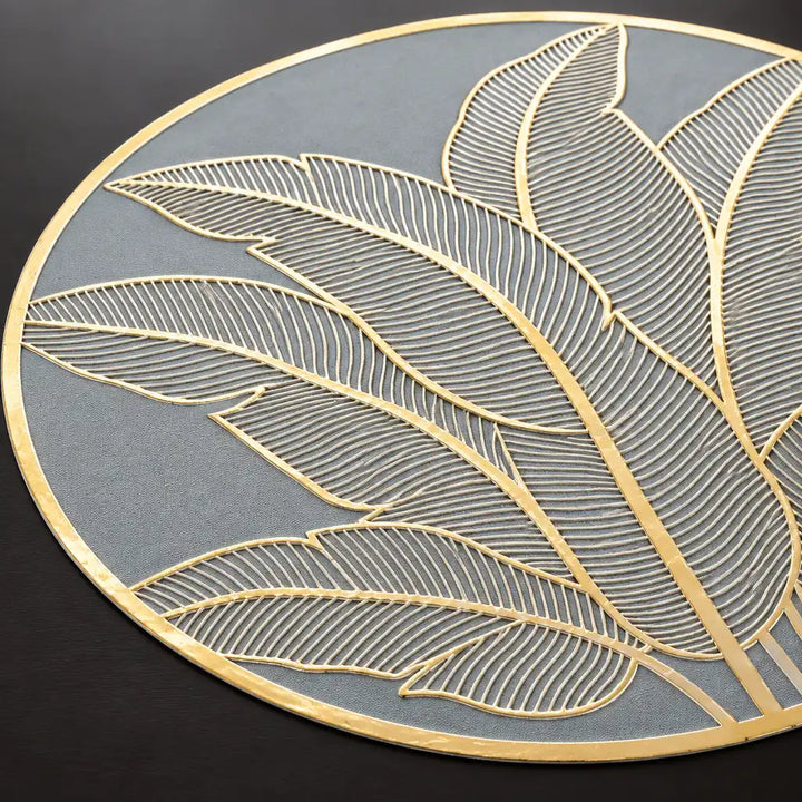 Close-up of grey round table topper mat with gold leaf pattern