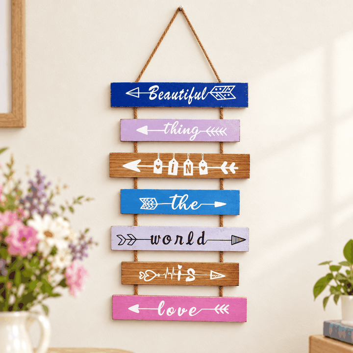 Multicolour arrow sign wall caption decor with seven hanging wooden strips and flowers