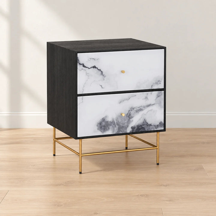 Cordero black nightstand with two marble effect drawer fronts and gold metal legs in natural light