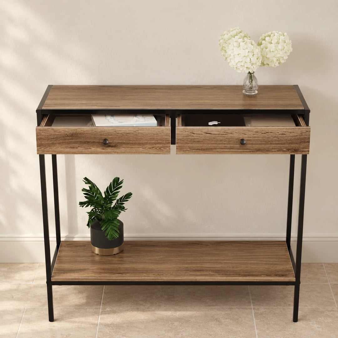 Dindo console table with two open wood-grain drawers, black metal frame and lower shelf in a softly lit entryway.