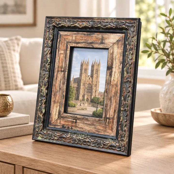 Dark ornate photo frame with light wood inner border and cathedral photo