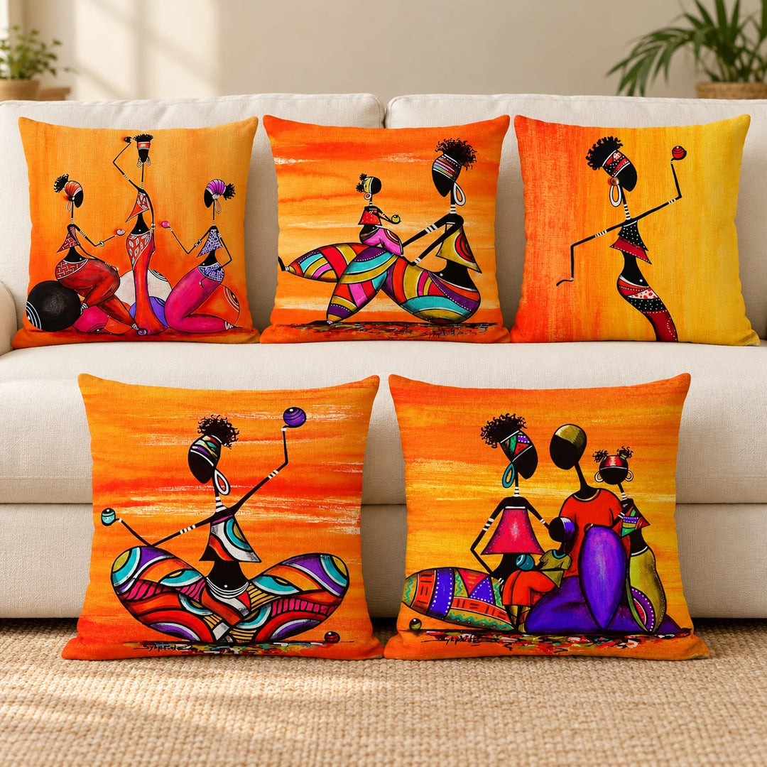 Five Egyptian Cleopatra cushion covers with colourful figurative prints arranged by a sofa
