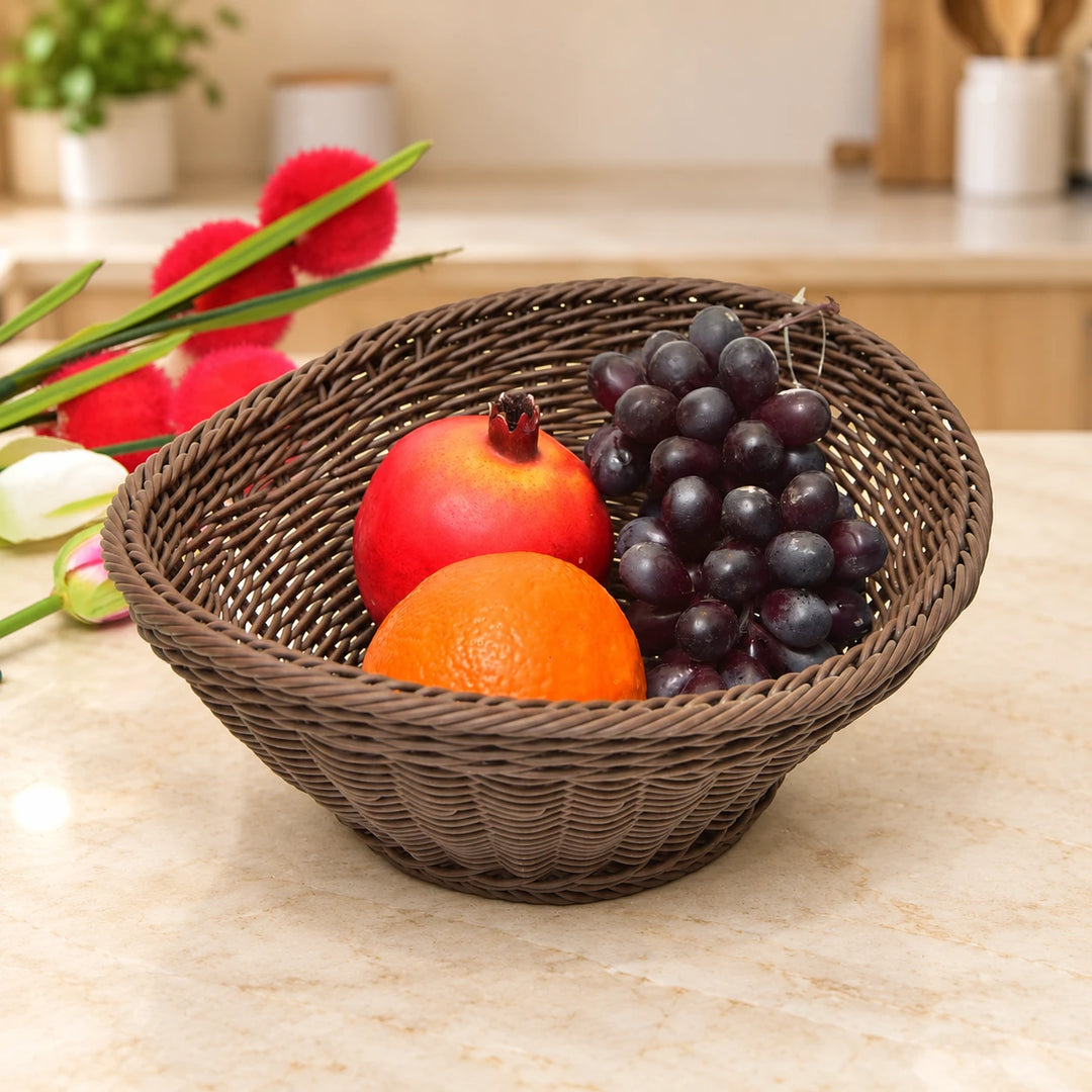 Dark brown oval basket with fruit on a kitchen counter