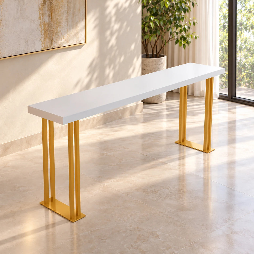 Feigned White console table with Akil Gold powder-coated legs in a sunlit home; decorative background props not included.