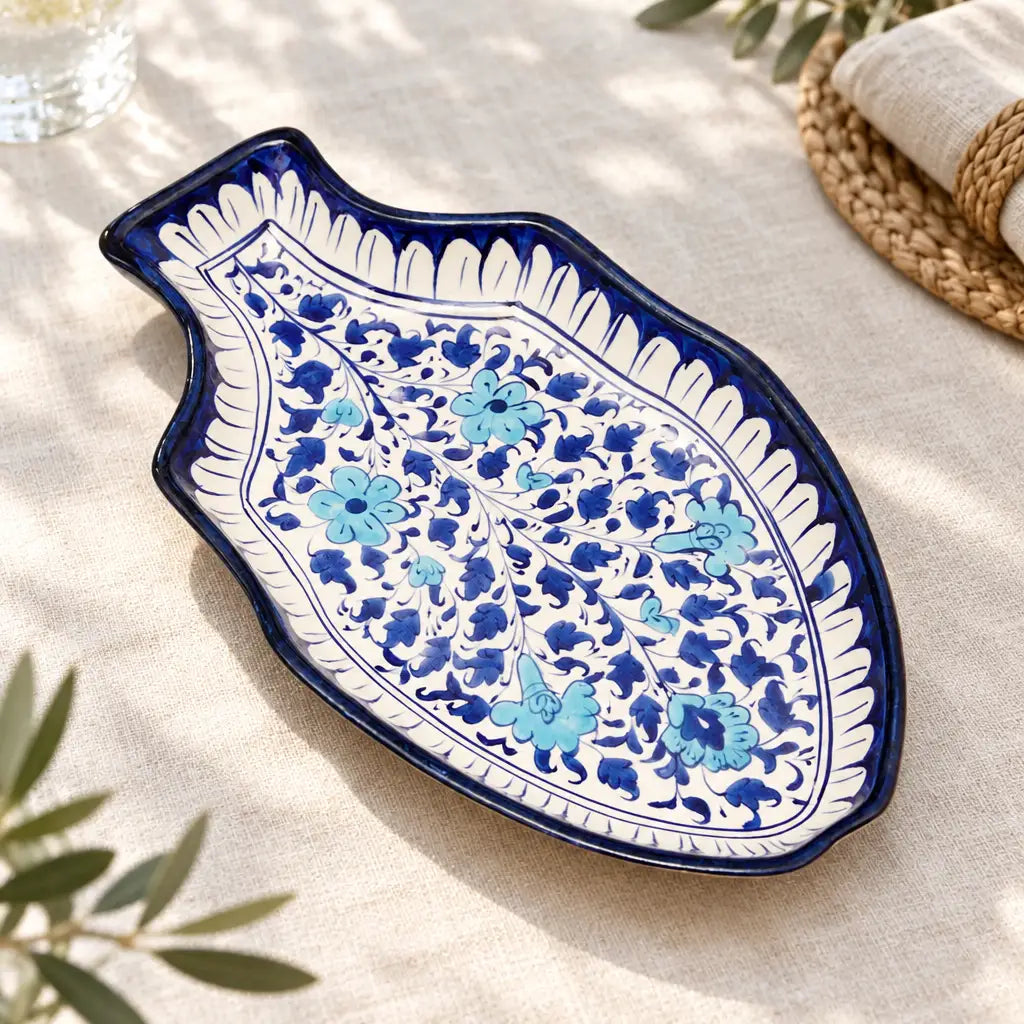 Blue and white floral ceramic fish shaped serving dish on linen tablecloth