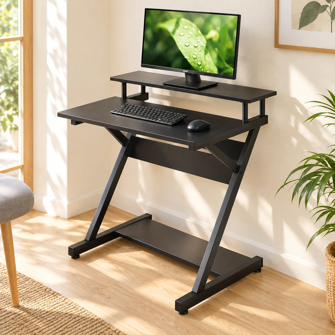 FITUEYES black Z-frame computer desk with raised monitor shelf and lower shelf in a bright home office