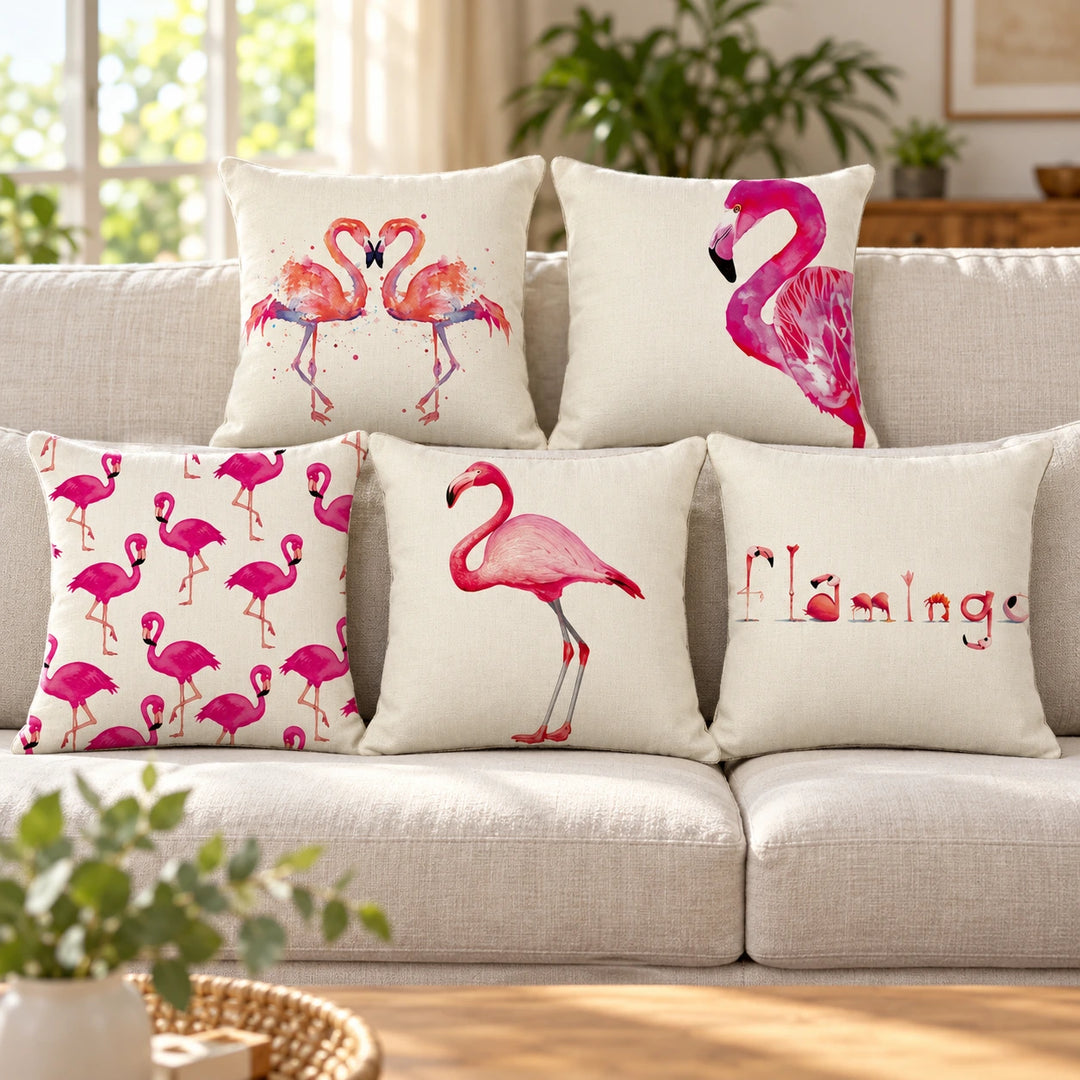 Set of five cream and pink flamingo print cushion covers in a bright living room setting