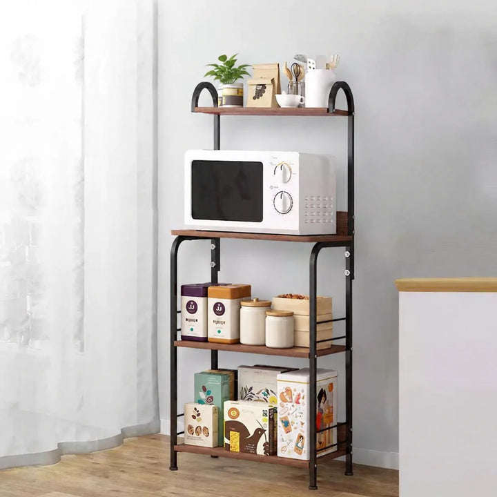 Four-tier black metal and wood kitchen rack with microwave, ceramic jars and a small plant