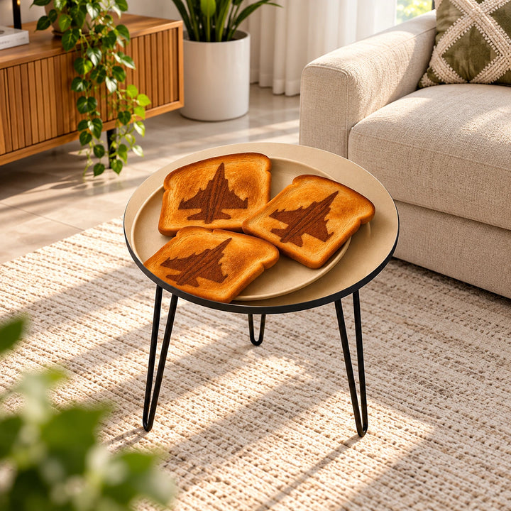 Round hairpin table with printed toast and fighter-jet artwork in a sunlit living room