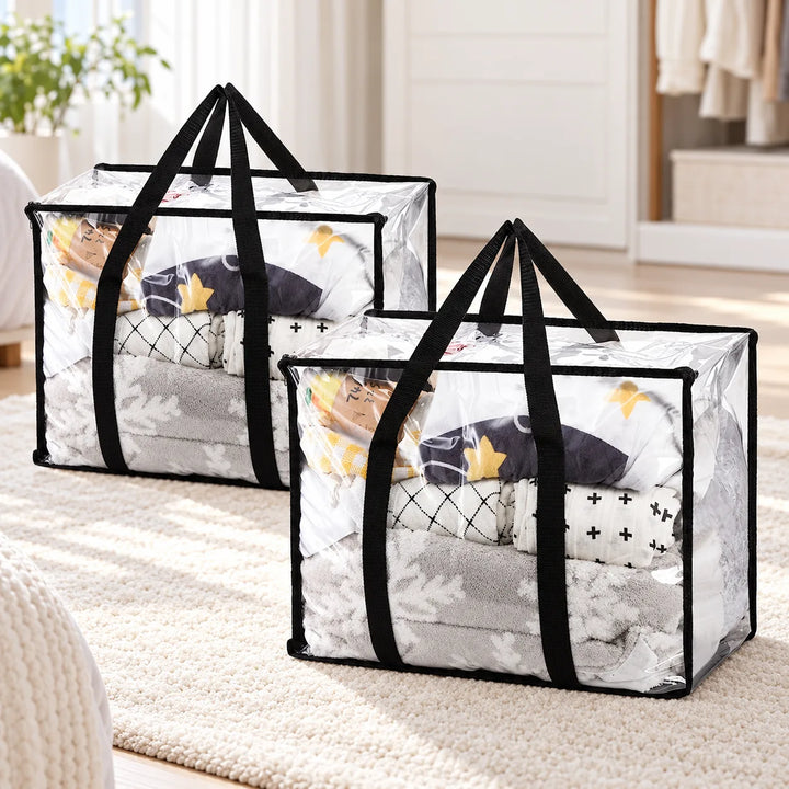 Pack of two Garms clear PVC storage bags with long black handles in a bedroom; bedding shown for styling.