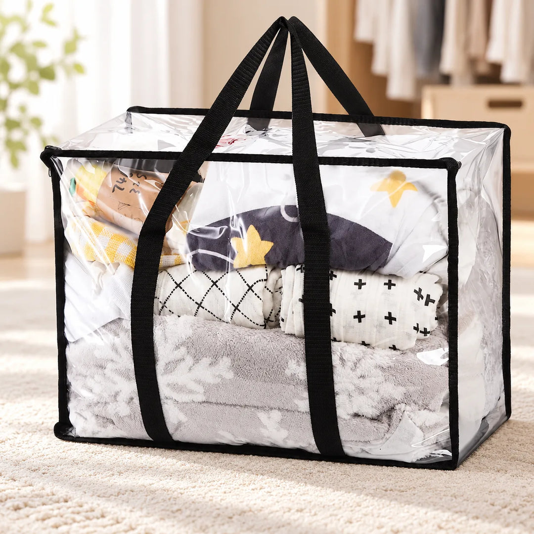 One Garms clear PVC storage bag with long black handles in a bedroom; bedding shown for styling.