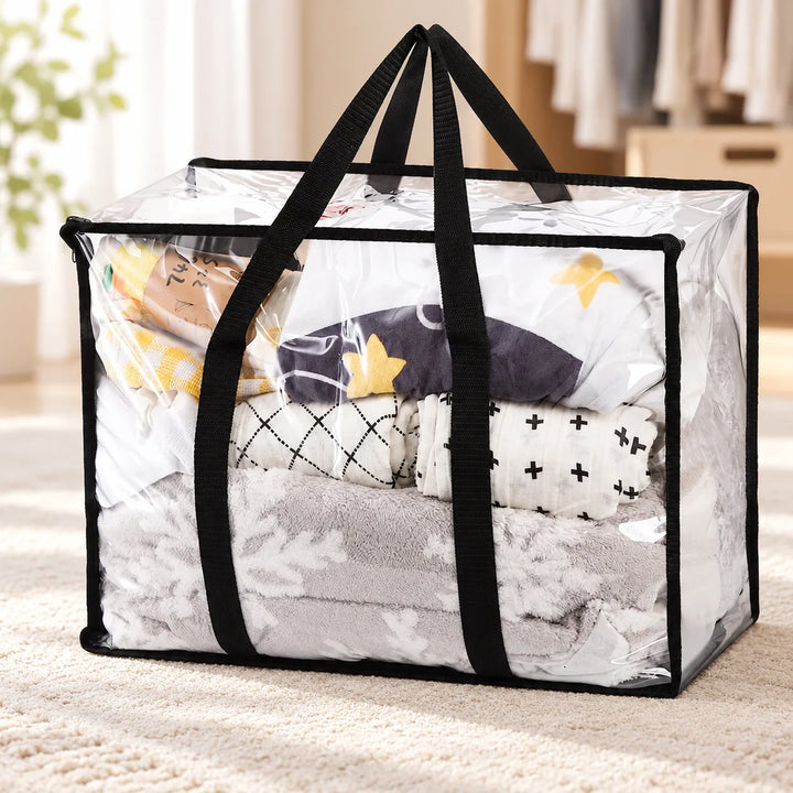 One Garms clear PVC storage bag with long black handles in a bedroom; bedding shown for styling.